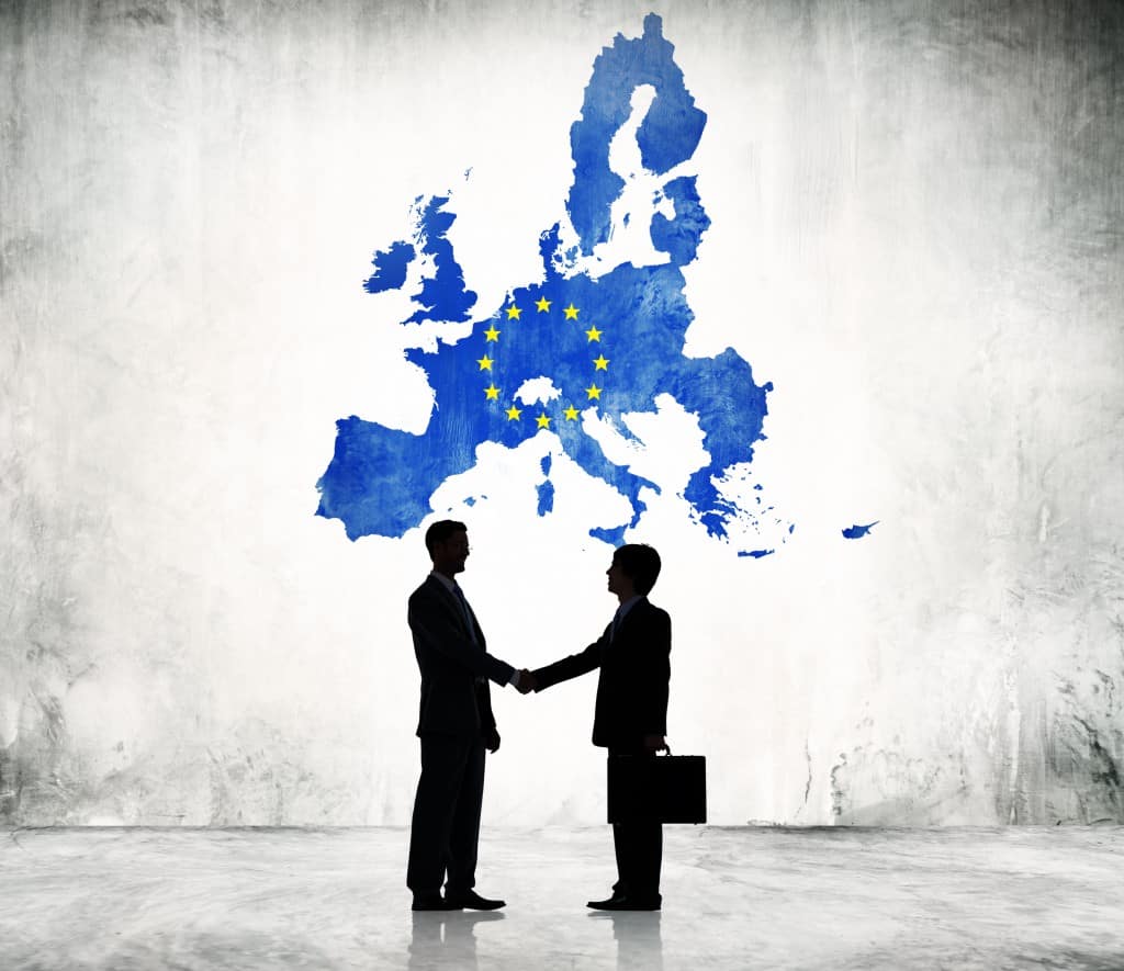 Two Businessman Shaking Hands With EU